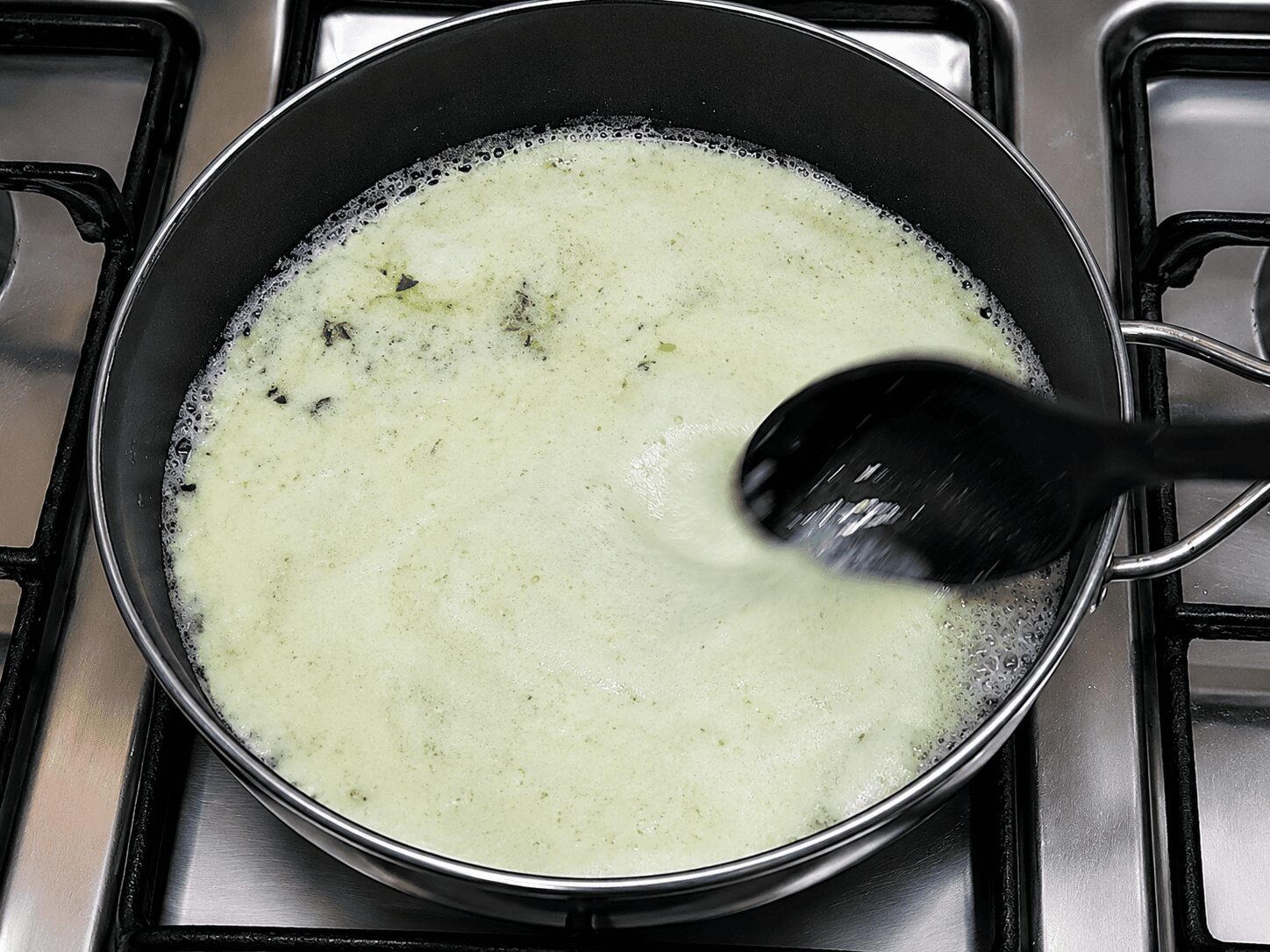 Frying onion and green chilli paste in oil and butter for Anda Malai Curry