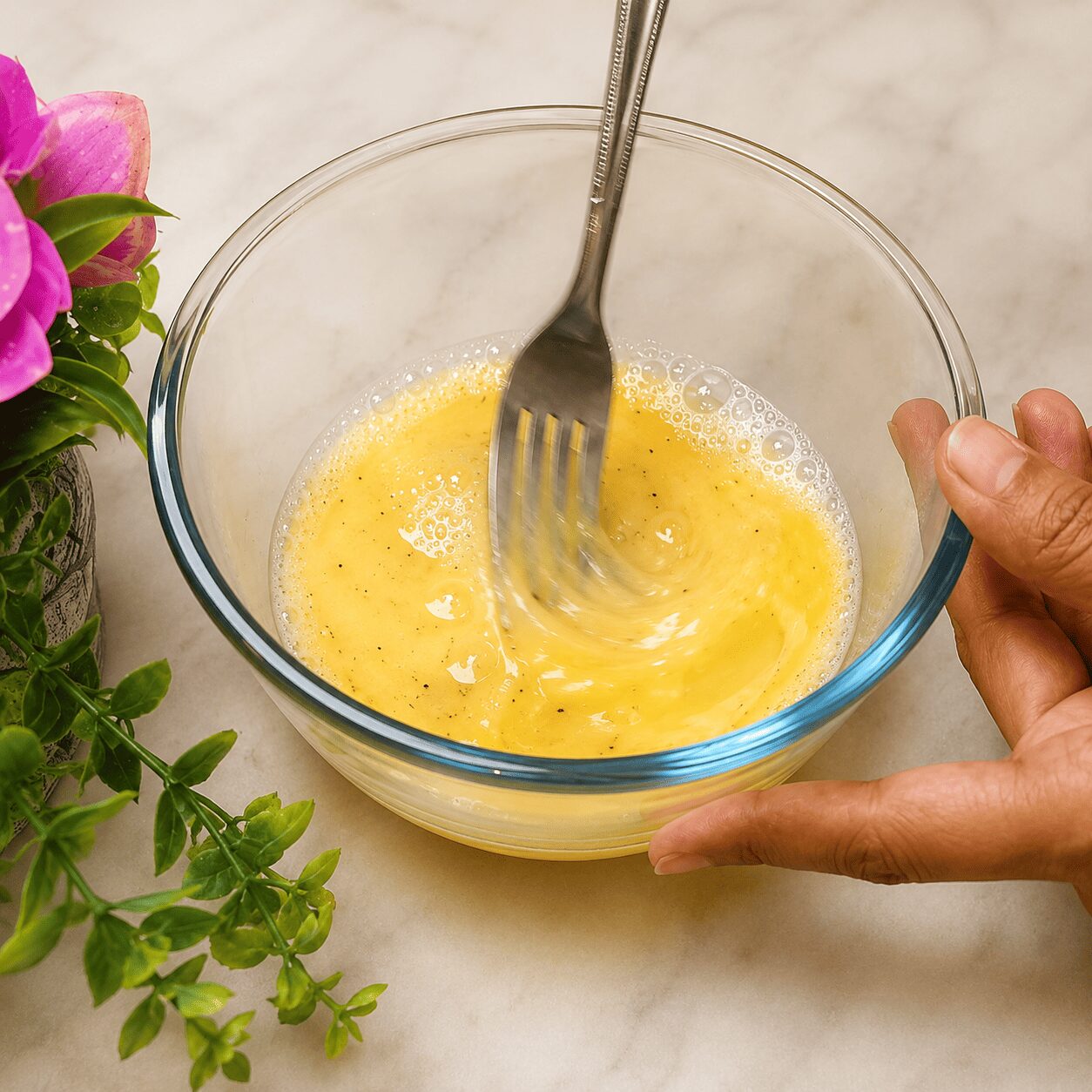 Beating the egg mixture with milk for a fluffier Butter Garlic Egg