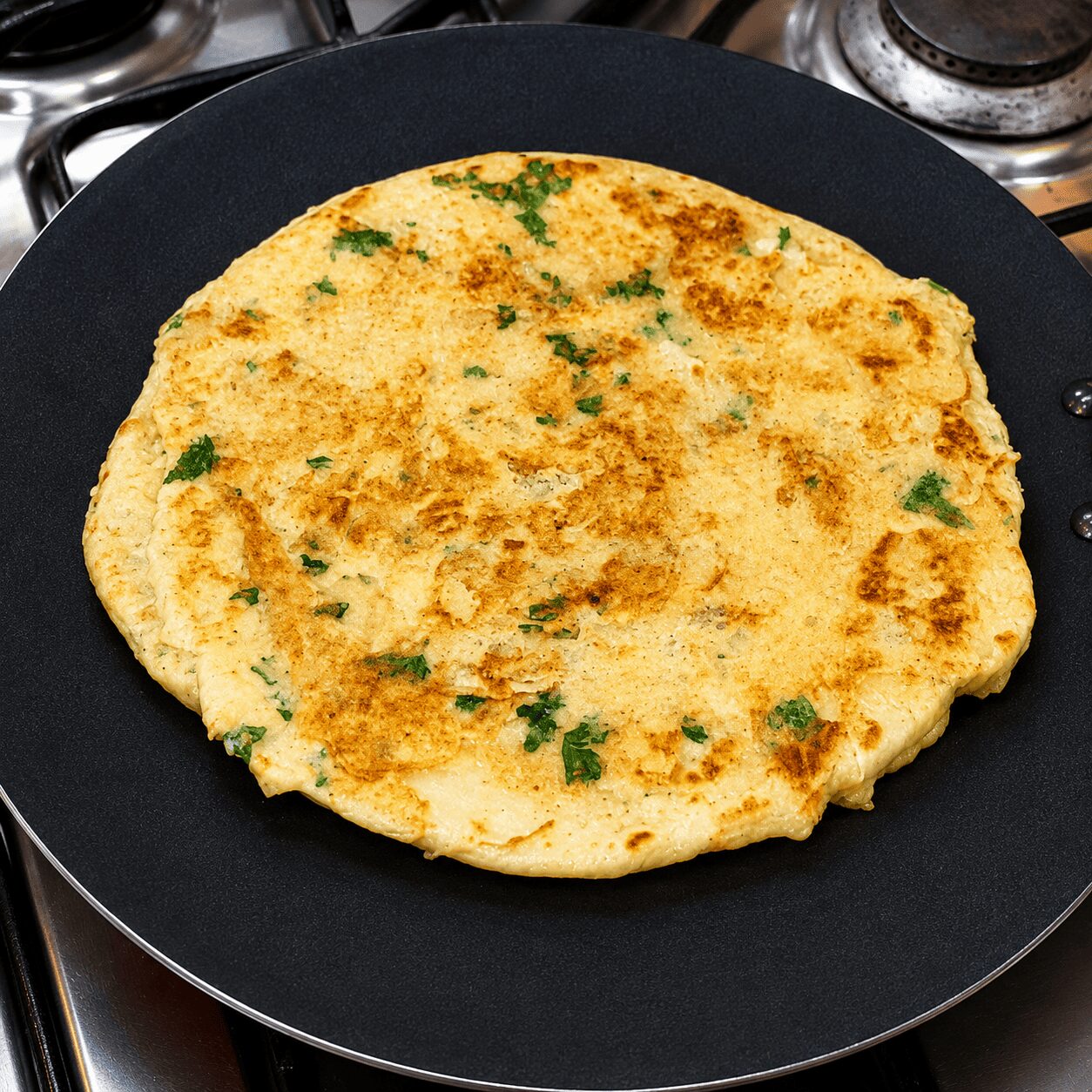 Flipped Anda Paratha Roll showing golden egg layer and crispy flaky layers