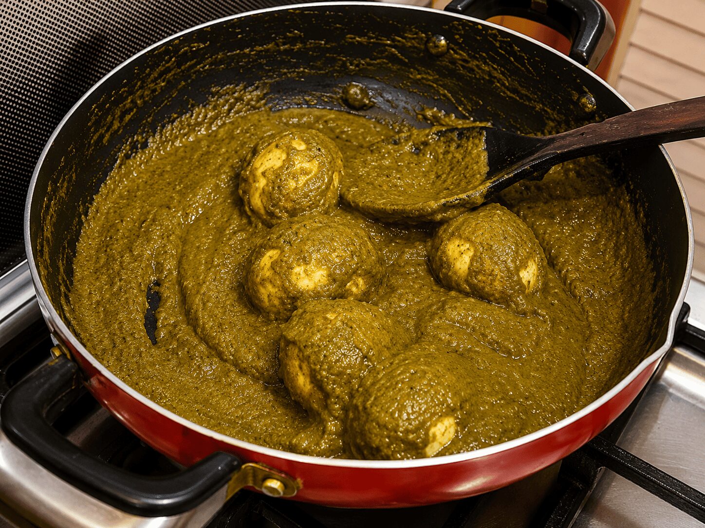 Fried eggs folded into the thick spinach masala for Anda Palak Butter Masala