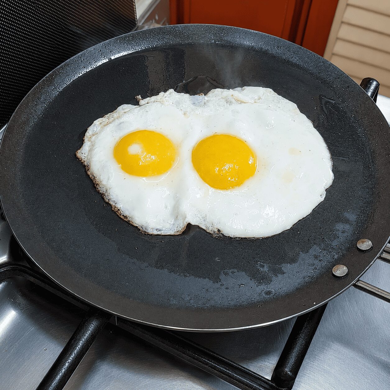 Gently cooking eggs covered with soft yolks for Turkish Eggs Çılbır