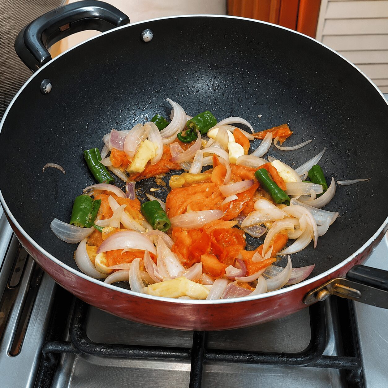 Softening onion, tomato, ginger, garlic, and chilli for Egg Kebab Curry gravy