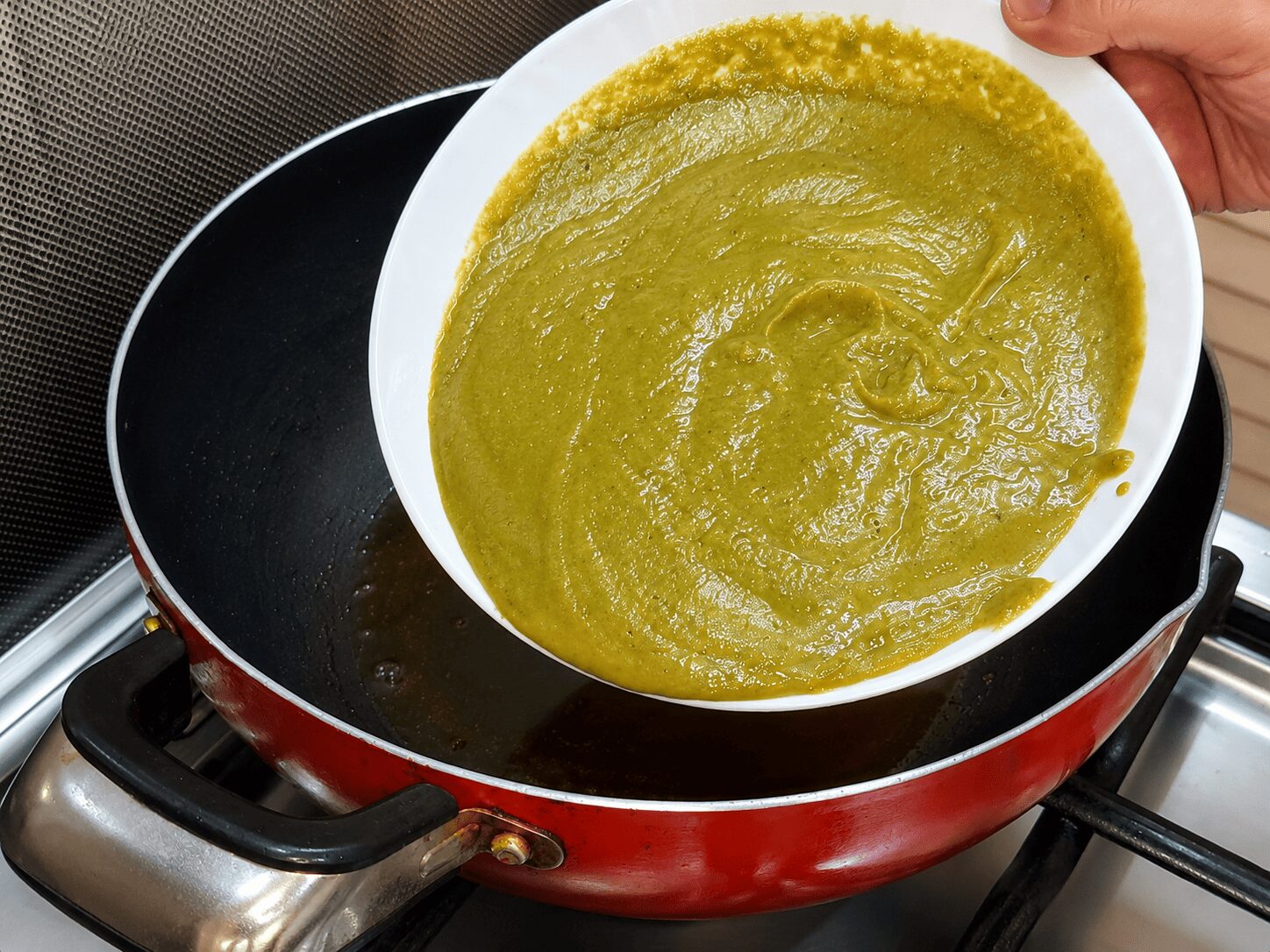Blended vivid green spinach-tomato-cashew paste for Anda Palak Butter Masala
