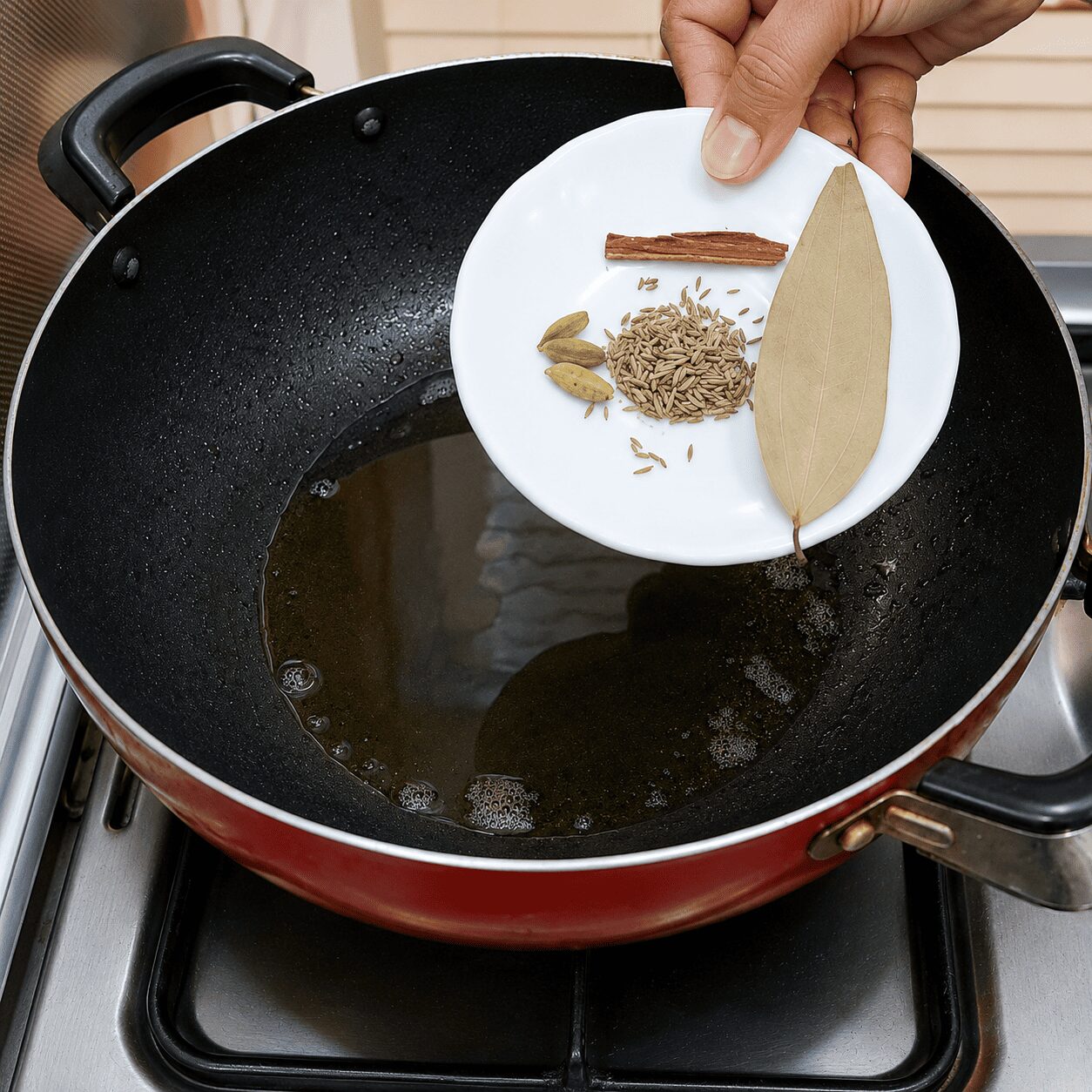 Tempering whole spices before adding the masala paste, Egg Kebab Curry
