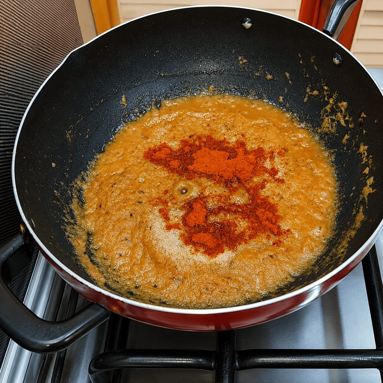 Tomato paste roasted with spices until oil separates for Anda Aloo Salan