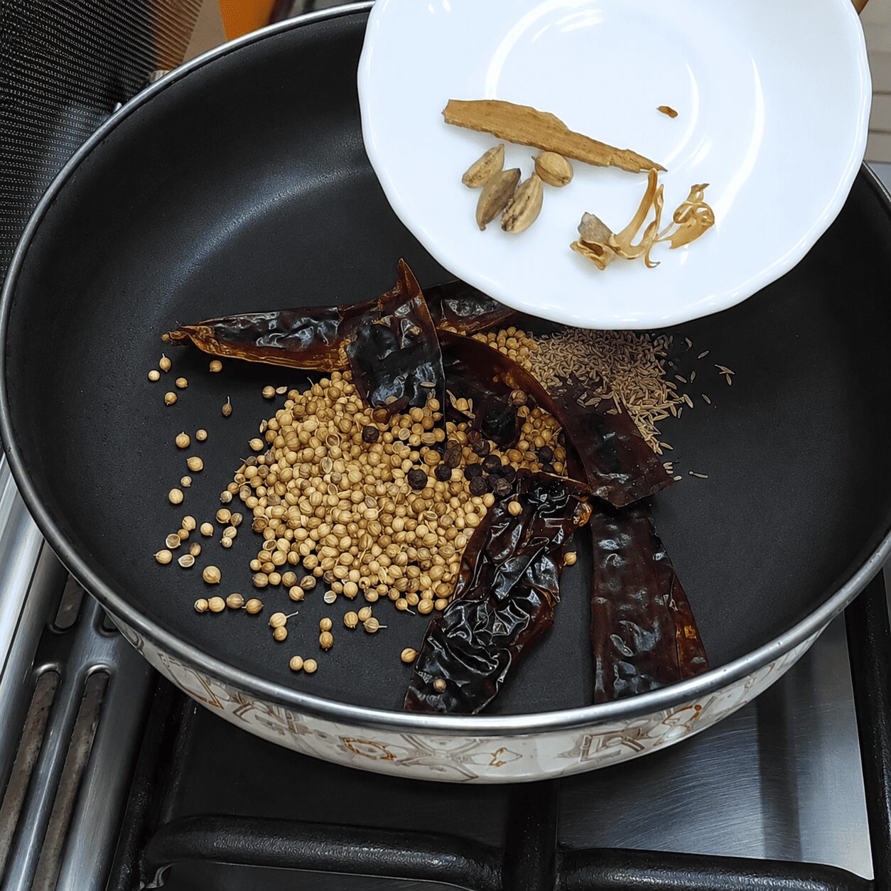 Whole spices dry-roasting for the freshly ground Chicken Dark Bunglow special masala
