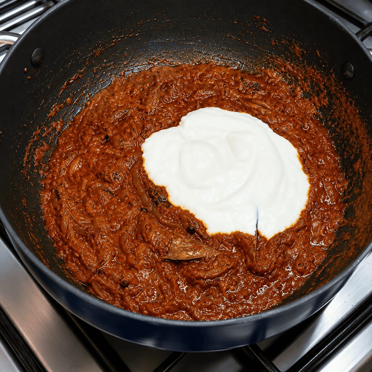 Yogurt korma masala cooking until oil resurfaces for anda korma biryani